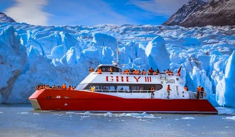 Catamaran sailing along the face of Grey Glacier on the Torres del Paine boat tour